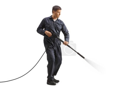 Photo for Full length shot of a man in a uniform using a pressure washer isolated on white background - Royalty Free Image