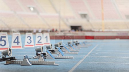Photo for Athletics starting blocks on a blue running track at a stadium - Royalty Free Image