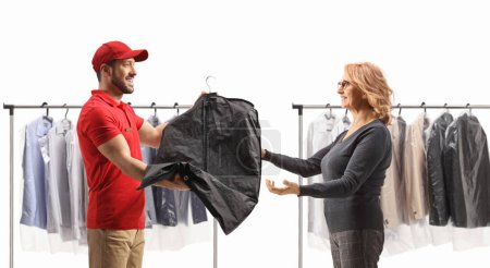 Photo for Man giving a suit to a woman at dry cleaners isolated on a white background - Royalty Free Image
