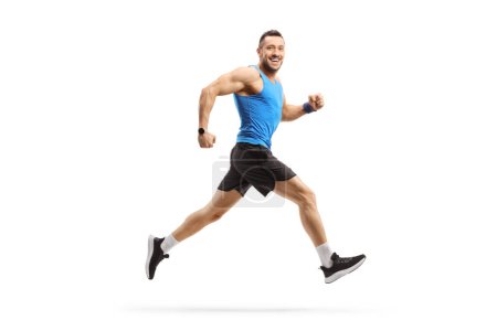 Photo for Full length profile shot of a man in sportswear running and smiling isolated on white background - Royalty Free Image