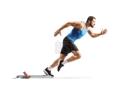 Photo for Full length profile shot of a male athlete on starting blocks starting a run isolated on white background - Royalty Free Image