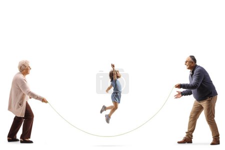 Photo for Grandparents playing skipping rope with granddaughter isolated on white background - Royalty Free Image
