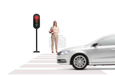 Photo for Car driving and a woman holding books and waiting at traffic lights isolated on white background - Royalty Free Image