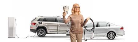 Photo for Woman holding money and EV charger isolated on white background - Royalty Free Image