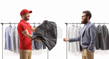 Photo for Man delivering dry cleaned clothes to a bearded man isolated on a white background - Royalty Free Image