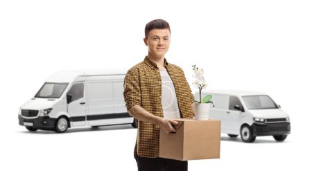 Photo for Guy standing in front of vans with a cardboard box and an orchid flower pot isolated on white background - Royalty Free Image