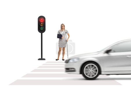 Photo for Young woman with an arm sling and a crutch waiting to cross a street isolated on white background - Royalty Free Image