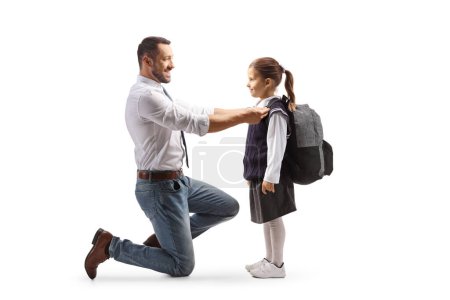 Foto de Perfil de cuerpo entero de un padre ayudando a una chica a prepararse para la escuela aislada sobre fondo blanco - Imagen libre de derechos