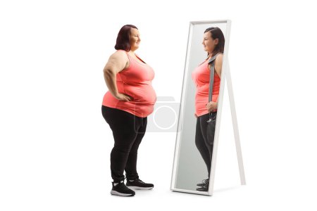 Übergewichtige Frau betrachtet eine schlankere Version ihrer selbst im Spiegel isoliert auf weißem Hintergrund