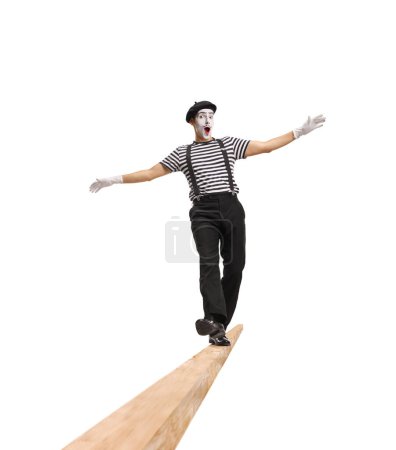 Photo for Cheerful mime walking on a wooden beam isolated on white background - Royalty Free Image