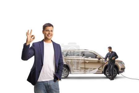 Foto de Cliente feliz con un gesto SUV ok signo en un lavado de coches aislado sobre fondo blanco - Imagen libre de derechos