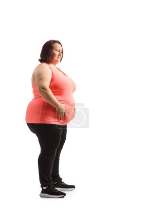 Photo for Overweight young woman holding her belly isolated on white background - Royalty Free Image