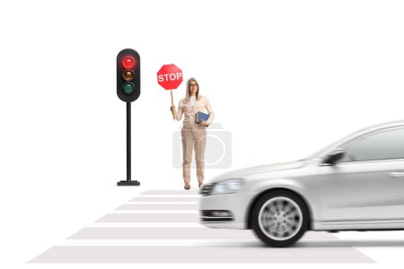 Photo for Young woman holding a book and a stop sign and standing near traffic lights isolated on white background - Royalty Free Image