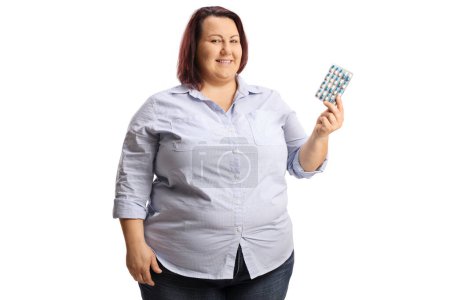 Photo for Overweight woman holding a pack of pills isolated on white background - Royalty Free Image
