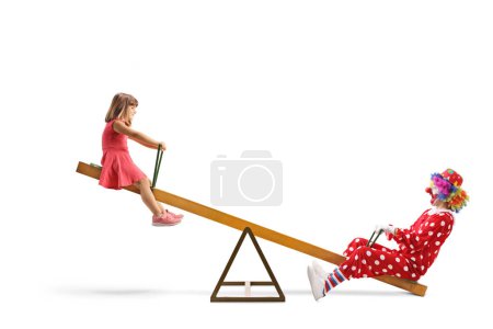 Photo for Little girl playing on a seesaw with a clown isolated on white background - Royalty Free Image