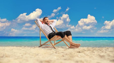 Photo for Bussinesman at the beach resting by the sea and enjoying sea breeze - Royalty Free Image