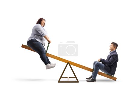 Photo for Corpulent woman playing on a seesaw with a young man isolated on white background - Royalty Free Image