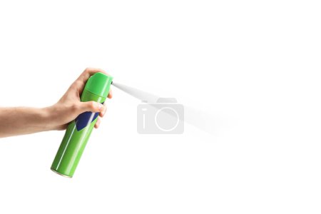 Foto de Male hand using a green bottle of spray isolated on white background - Imagen libre de derechos