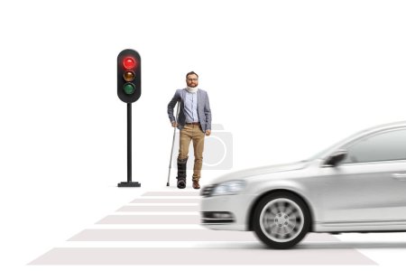 Photo for Man with a broken leg waiting at traffic lights isolated on white background - Royalty Free Image
