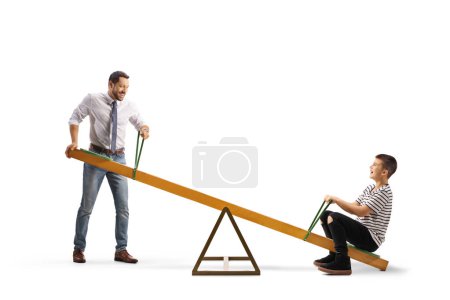 Photo for Father playing on a seesaw with a boy isolated on white background - Royalty Free Image
