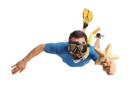 Foto de Man in a suit snorkeling with fins and a mask and holding a sea star isolated on white background - Imagen libre de derechos