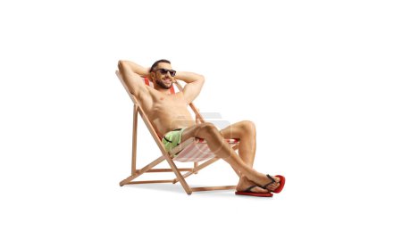 Photo for Guy in swimwear enjoying on a beach chair isolated on white backgroun - Royalty Free Image