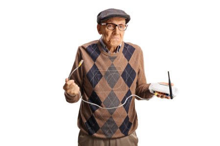 Téléchargez les photos : Confused elderly man holding a router isolated on white background - en image libre de droit