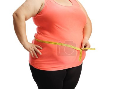 Téléchargez les photos : Overweight female torso measuring waist isolated on white background - en image libre de droit