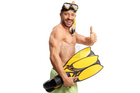 Photo for Cheerful young man in swimwear with a diving mask and snorkeling fins gesturing thumbs up isolated on white background - Royalty Free Image