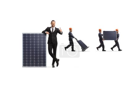 Photo for Businesswman gesturing thumbs up and factory workers carrying photovoltaic panels isolated on white background - Royalty Free Image