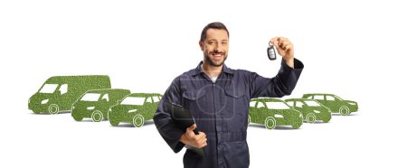 Photo for Car mechanic holding a clipboard and keys in front of green eco-friendly vehicles isolated on white background - Royalty Free Image