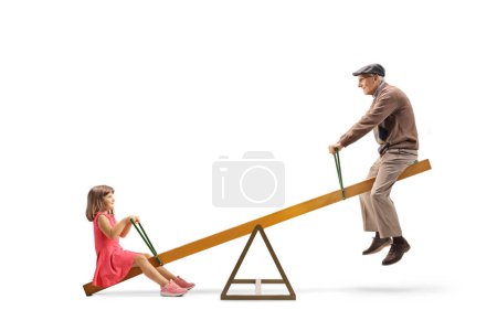 Photo for Little girl playing on a seesaw with her grandfather isolated on white background - Royalty Free Image
