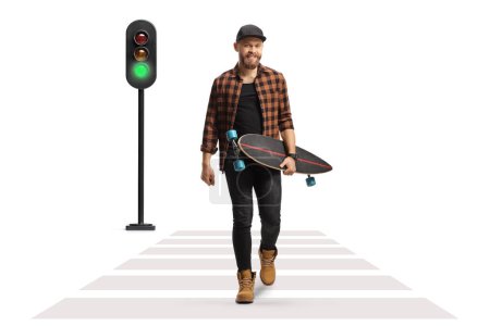 Photo for Guy walking and carrying a longboard at a pedestrian crosswalk isolated on white background - Royalty Free Image