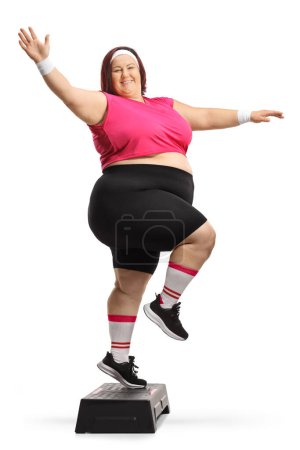 Photo for Cheerful plus size woman exercising step aerobics isolated on white background - Royalty Free Image