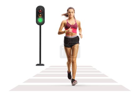 Photo for Full length portrait of a young female athlete running on a street isolated on white background - Royalty Free Image