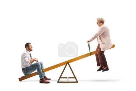 Photo for Elderly woman and young man playing on a seesaw isolated on white background - Royalty Free Image