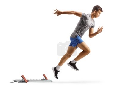 Photo for Full length profile shot of a fit guy at running start blocks isolated on white background - Royalty Free Image