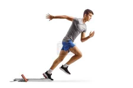 Photo for Full length profile shot of a fit young man running from start blocks isolated on white background - Royalty Free Image