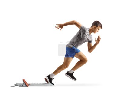 Photo for Full length profile shot of a guy beginning a race from start blocks isolated on white background - Royalty Free Image