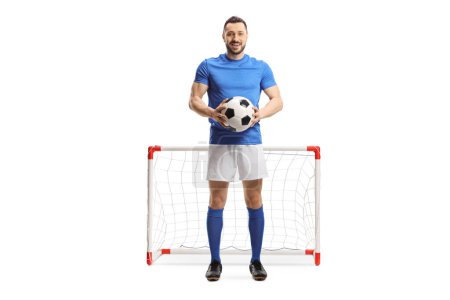 Photo for Full length portrait of a goalkeeper holding a ball and looking at the camera isolated on white background - Royalty Free Image