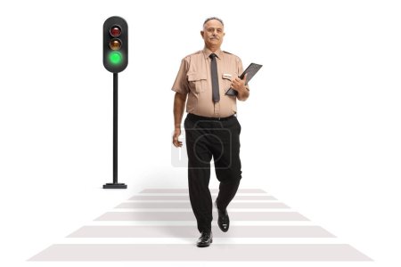 Photo for Full length portrait of a security officer holding a clipboard and crossing a street isolated on white background - Royalty Free Image