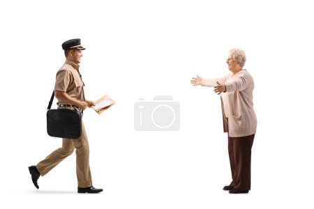 Photo for Mailman delivering a letter to a happy elderly woman isolated on white background - Royalty Free Image