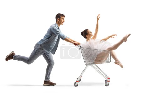 Photo for Guy pushing a ballerina inside a shopping cart isolated on white background - Royalty Free Image