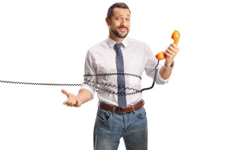 Photo for Man tied with a cable from a vintage rotary phone isolated on white background - Royalty Free Image