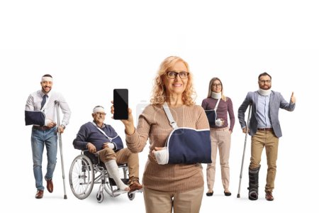 Photo for Female patient with a smartphone and a group of people with crutches and a wheelchair, trauma and injury isolated on white background - Royalty Free Image