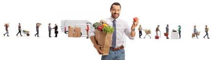 Téléchargez les photos : Homme avec un sac d'épicerie tenant une tomate devant les agriculteurs livrant des légumes au marché isolé sur fond blanc - en image libre de droit