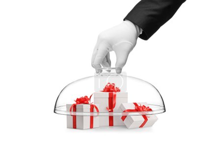 Foto de Una mano enguantada que cubre cajas de regalo con una cúpula de vidrio aislada sobre fondo blanco - Imagen libre de derechos