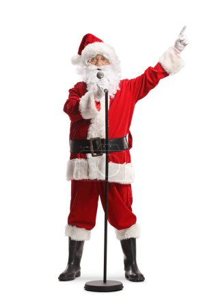 Photo for Santa claus with a microphone singing and pointing with finger isolated on white background - Royalty Free Image