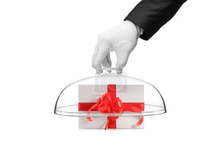 Photo for Bellboy hand covering gift box with a glass dome isolated on white background - Royalty Free Image