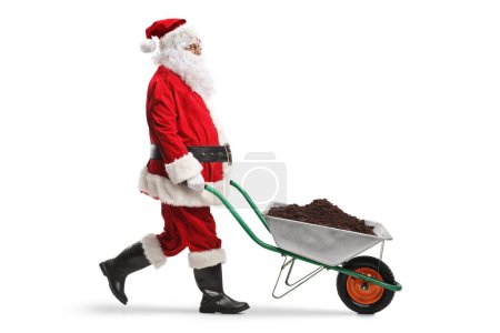Photo for Santa claus walking and pushing soil in a wheelbarrow isolated on white background - Royalty Free Image